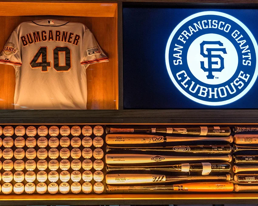 Giants player jerseys, baseballs, and bats on display at Giants Clubhouse, SFO